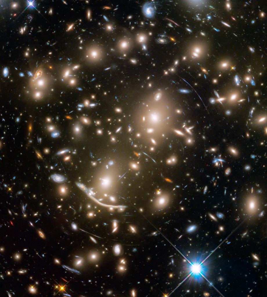 This Hubble Space Telescope mosaic shows part of the large Coma cluster of galaxies, which contains more than 1,000 galaxies and is located 300 million light-years away.  The rapid motion of its galaxies was the first clue that dark matter existed.  Image credit: NASA, ESA, J. Mack (STScI) and J. Madrid (Australian Telescope National Facility